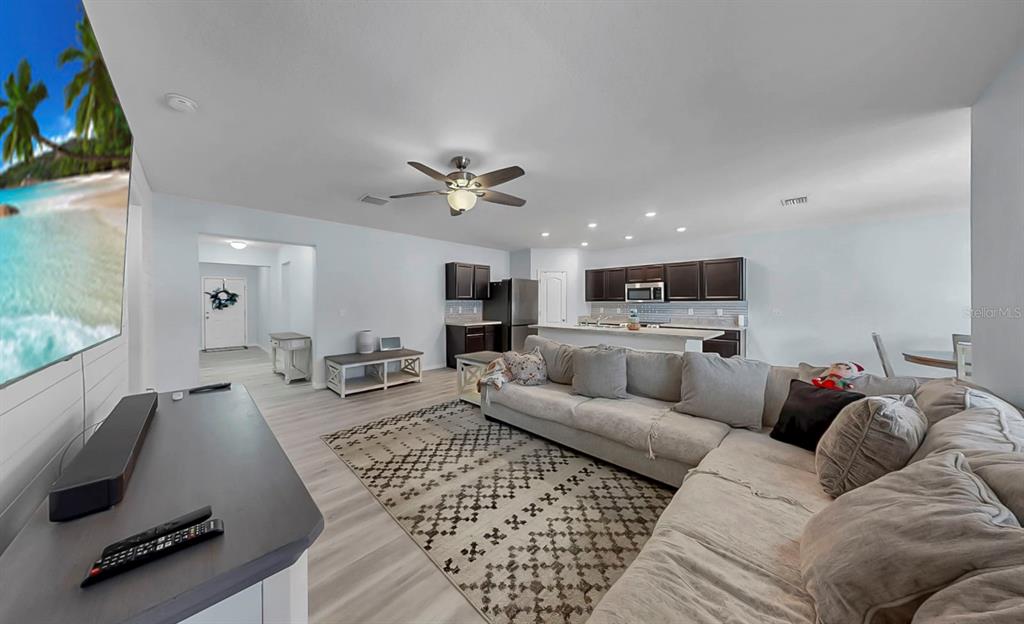 14530 Haddon Mist Drive Wimauma, FL 33598 - Photo 12 of 44 a living room with furniture and a flat screen tv