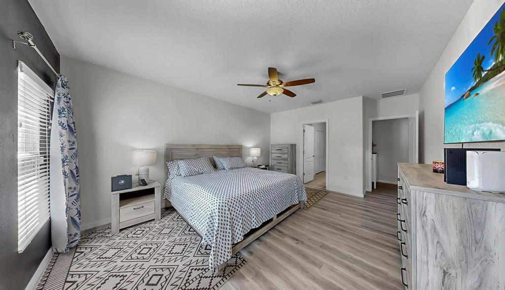 14530 Haddon Mist Drive Wimauma, FL 33598 - Photo 14 of 44 a bedroom with a bed and a view of kitchen