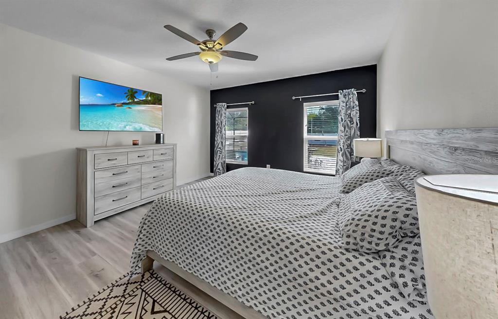 14530 Haddon Mist Drive Wimauma, FL 33598 - Photo 15 of 44 a bedroom with a bed and a flat screen tv