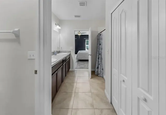 a bathroom with a double vanity sink and a mirror
