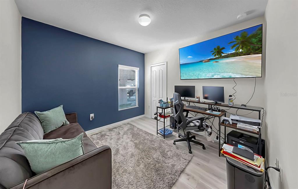 14530 Haddon Mist Drive Wimauma, FL 33598 - Photo 21 of 44 a living room with furniture a flat screen tv and a window