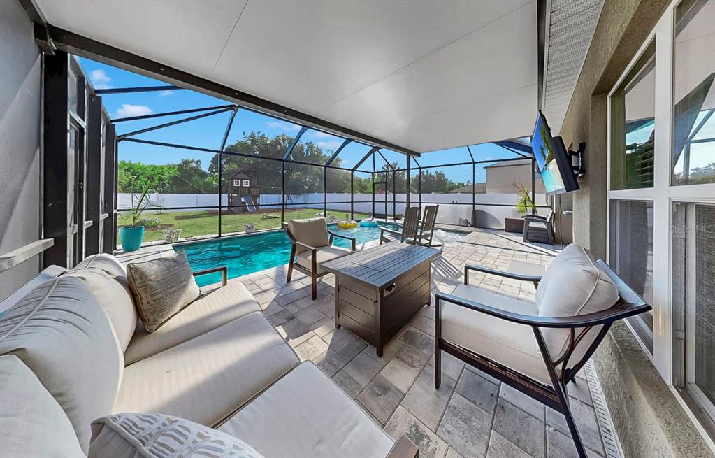14530 Haddon Mist Drive Wimauma, FL 33598 - Photo 23 of 44 a living room with furniture and a floor to ceiling window