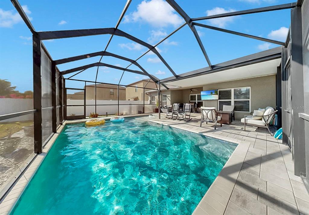 14530 Haddon Mist Drive Wimauma, FL 33598 - Photo 25 of 44 a view of a patio with table and chairs under an umbrella