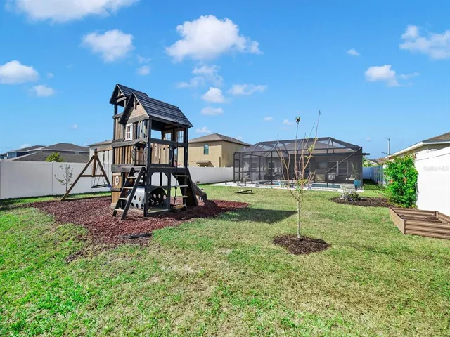 a view of a house with backyard and porch