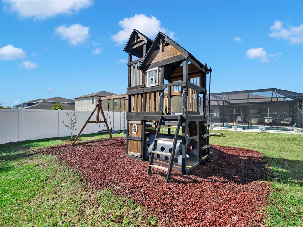 14530 Haddon Mist Drive Wimauma, FL 33598 - Photo 34 of 44 a view of a house with backyard porch and sitting area