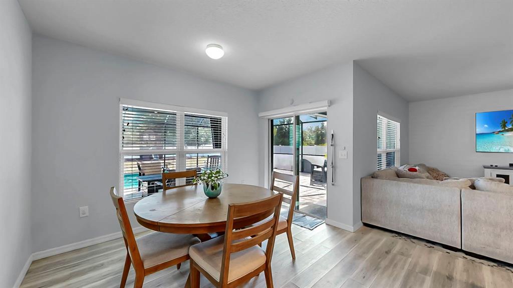 14530 Haddon Mist Drive Wimauma, FL 33598 - Photo 8 of 44 a living room with furniture a large window and wooden floor