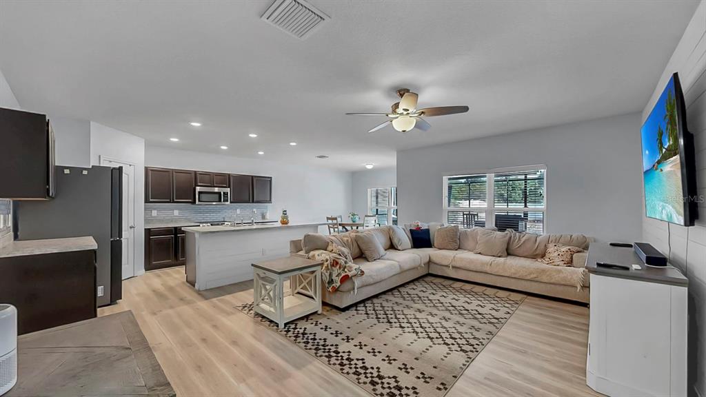 14530 Haddon Mist Drive Wimauma, FL 33598 - Photo 10 of 44 a living room with furniture and a flat screen tv