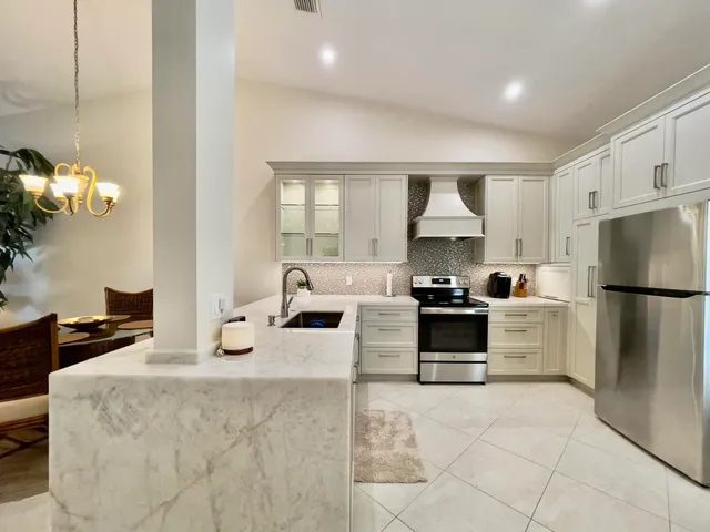 a kitchen with a white stove top oven and refrigerator
