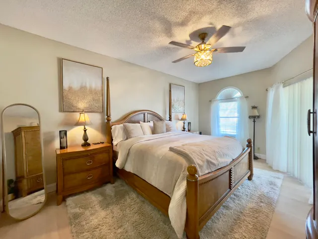 a bedroom with a bed and a chandelier