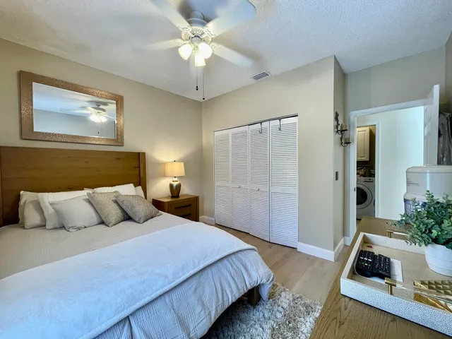 a bedroom with a bed and a potted plant