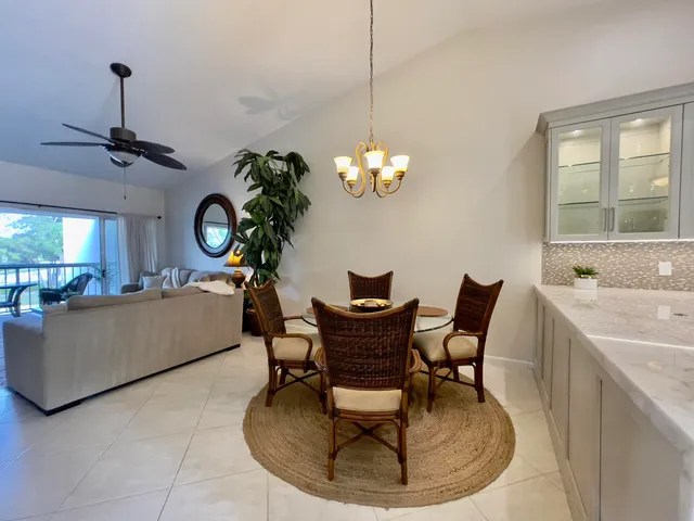 a living room with couches and a chandelier