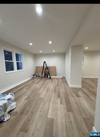 a view of a room with wooden floor and furniture