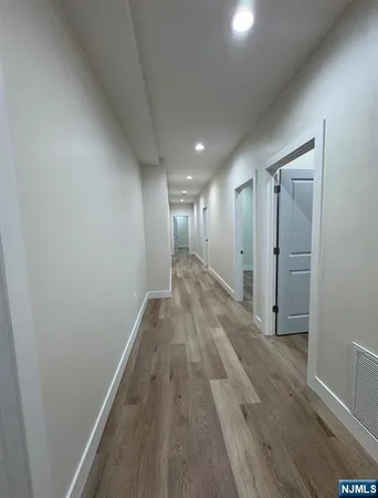 a view of hallway with wooden floor