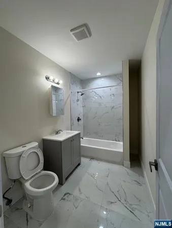 a bathroom with a toilet sink and bathtub