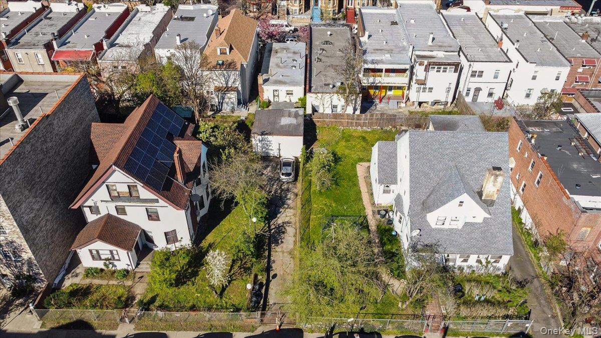 1428 Doris Street Bronx, NY 10462 - Photo 15 of 26 an aerial view of a residential apartment building with a yard and parking spaces