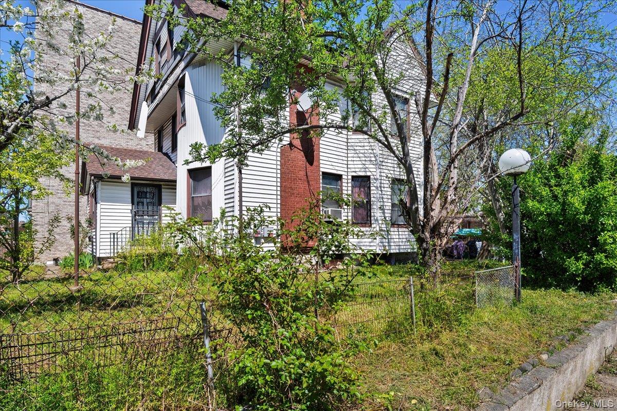1428 Doris Street Bronx, NY 10462 - Photo 4 of 26 a view of a house with a yard and potted plants