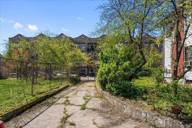 a backyard of a house with a garden and plants
