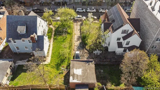 an aerial view of house with yard swimming pool and outdoor seating