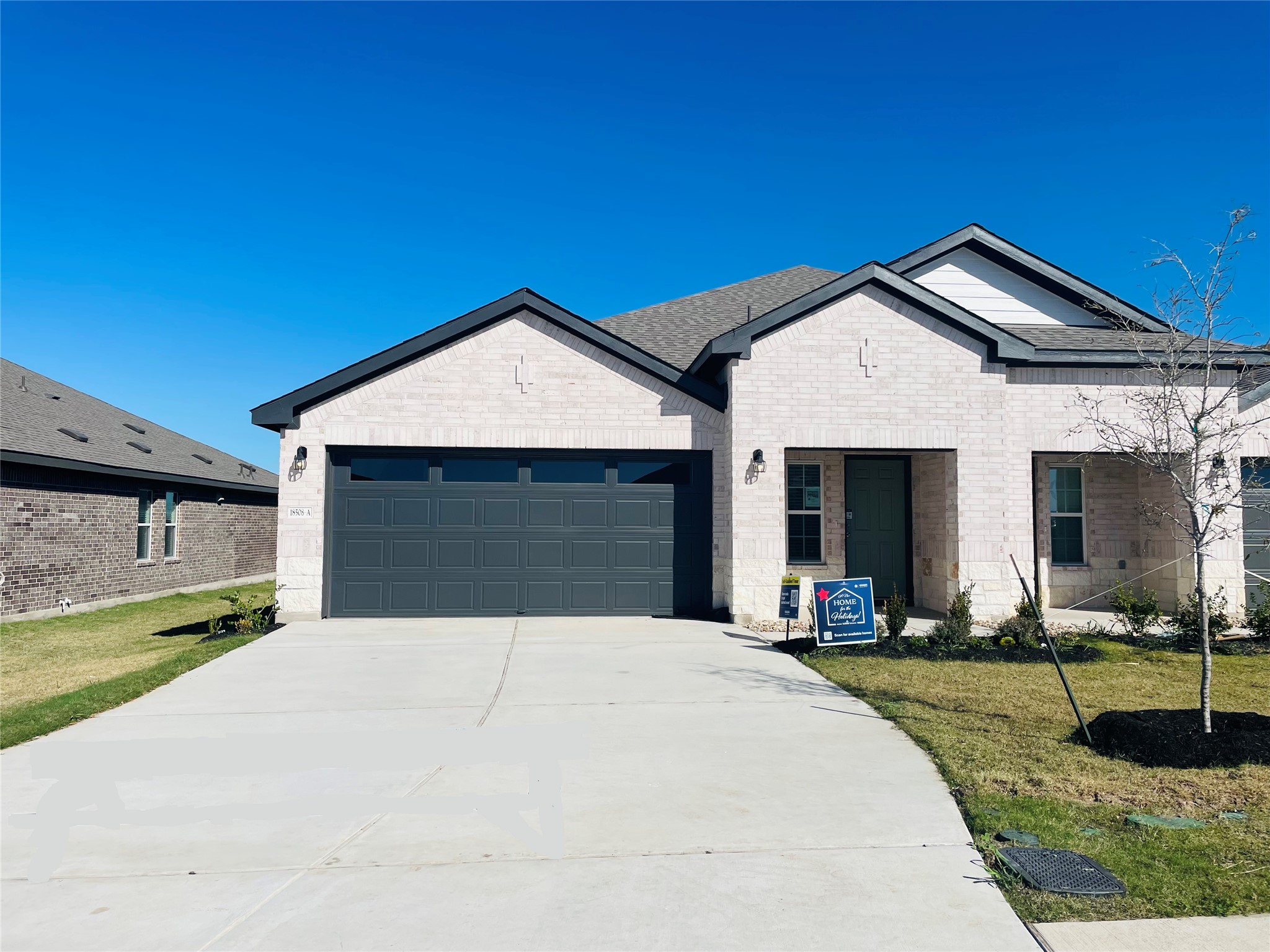 18508 A High Flyer Way Manor Manor, TX 78653 - Photo 1 of 32 Single story home featuring brick siding, a front lawn, a garage, and concrete driveway