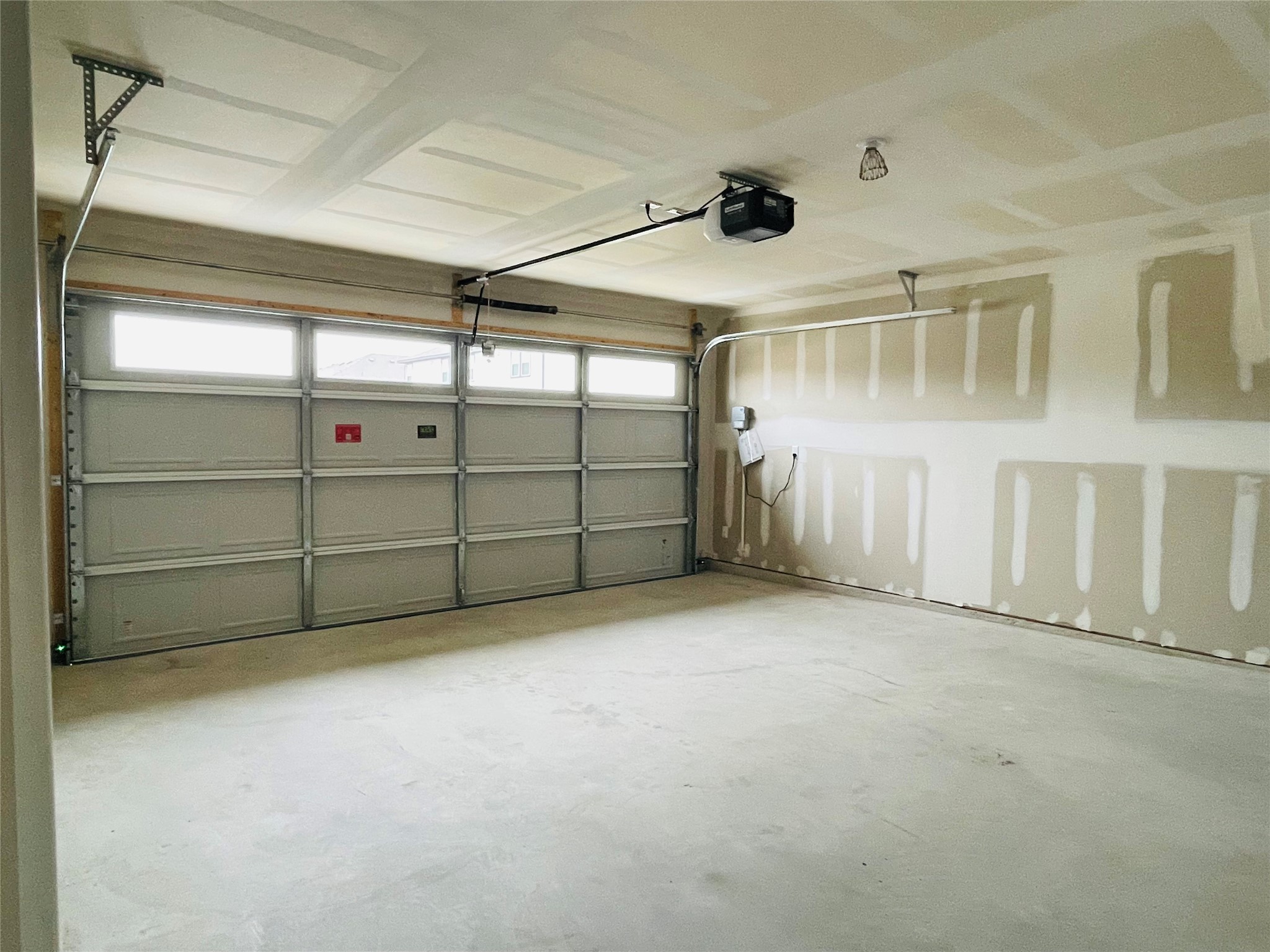 18508 A High Flyer Way Manor Manor, TX 78653 - Photo 19 of 32 Garage featuring a garage door opener