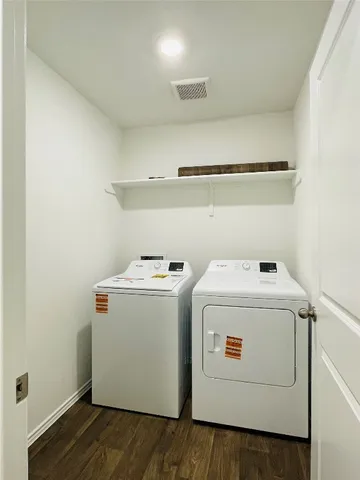 a kitchen with kitchen island a white cabinets and stainless steel appliances