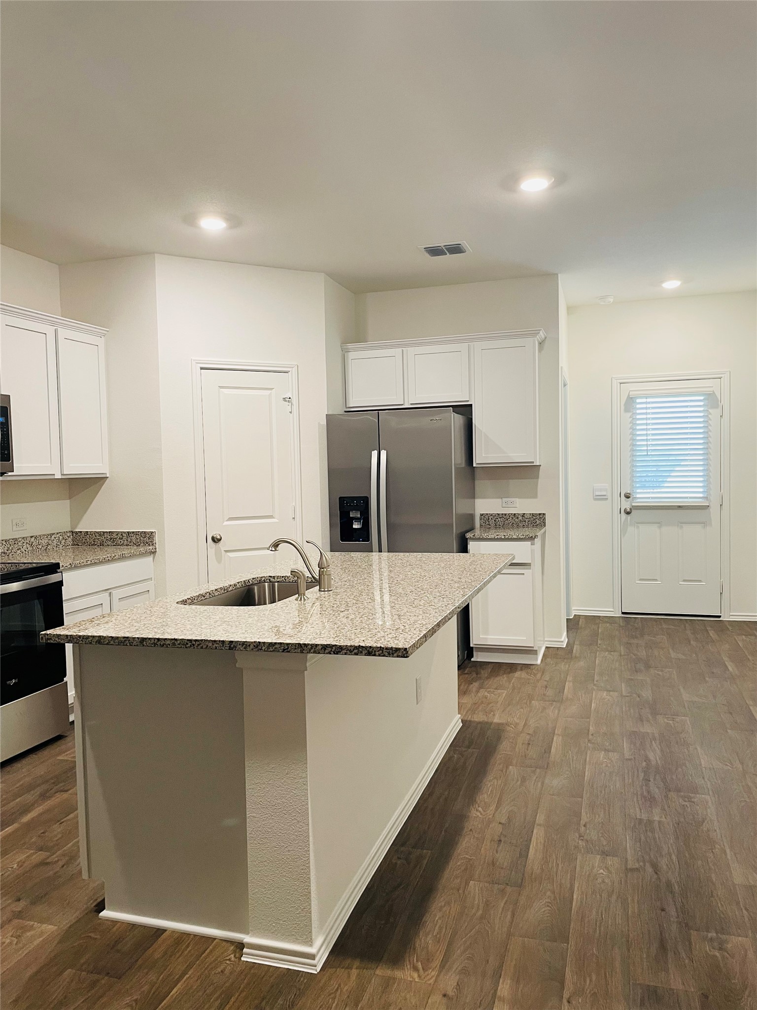 18508 A High Flyer Way Manor Manor, TX 78653 - Photo 9 of 32 Kitchen featuring stainless steel appliances, granite counters, white cabinetry