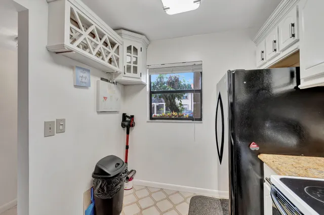 a kitchen with stainless steel appliances granite countertop a refrigerator and a stove