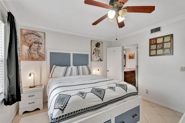 a bedroom with a bed and a ceiling fan
