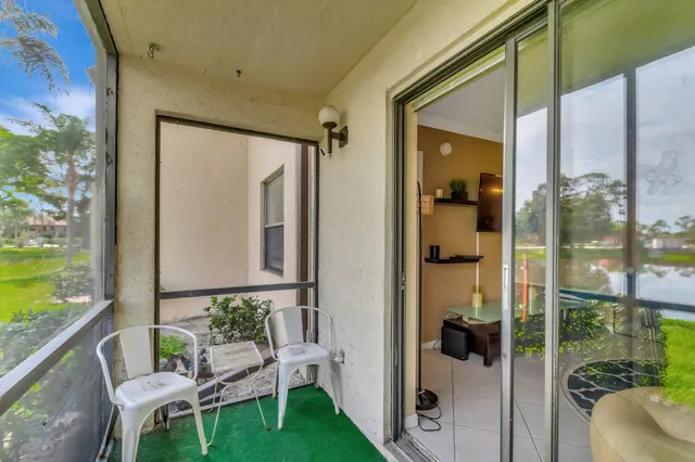 a balcony with table and chairs