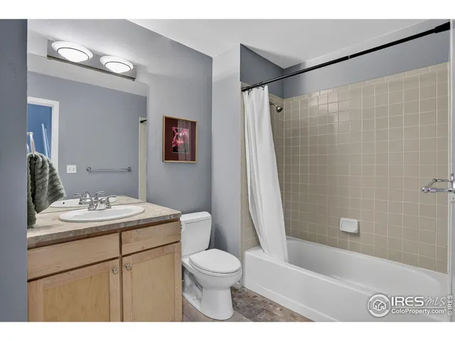 a bathroom with a sink a toilet a mirror a vanity and shower