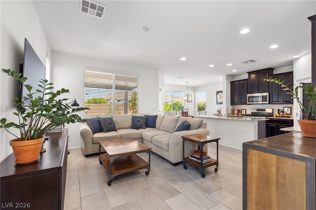 891 Earth Luster Road Las Vegas, NV 89178 - Photo 46 of 48 An inviting great room with an open floorplan seamlessly connects the living area to a well-appointed kitchen.