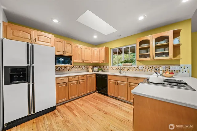 a kitchen with granite countertop a sink stainless steel appliances and cabinets