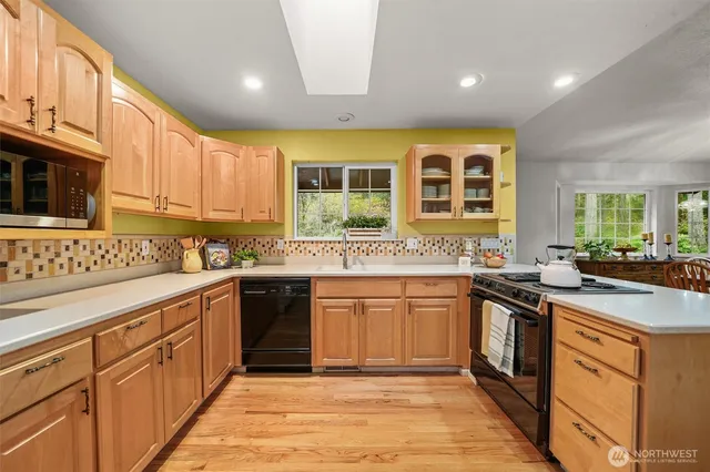a kitchen with stainless steel appliances granite countertop a stove and cabinets