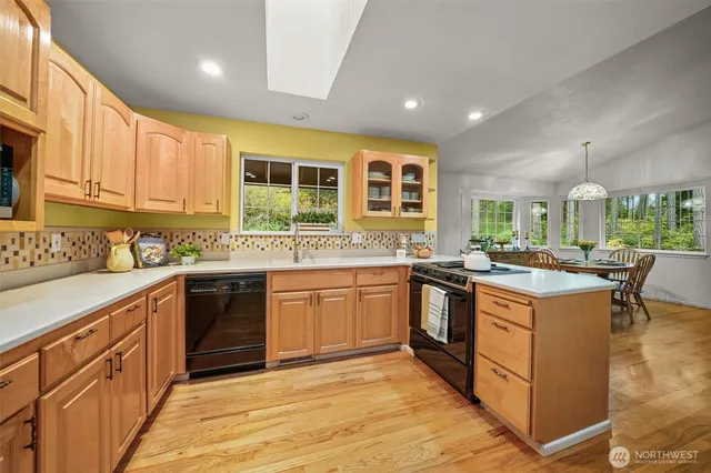 a kitchen with stainless steel appliances granite countertop a stove and cabinets