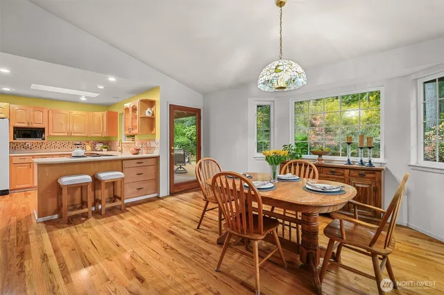 a dining room with furniture a chandelier and wooden floor