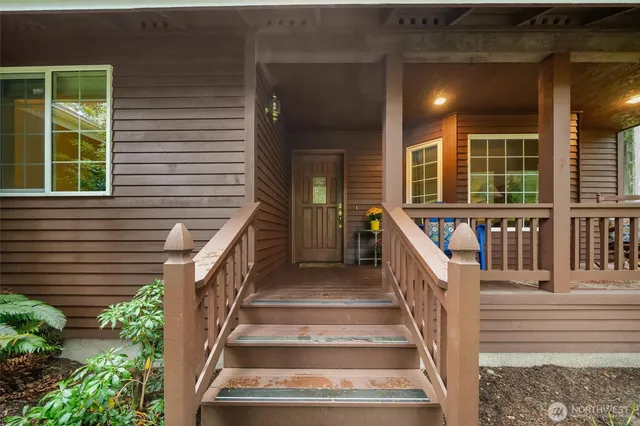 a view of a house with wooden fence and two windows