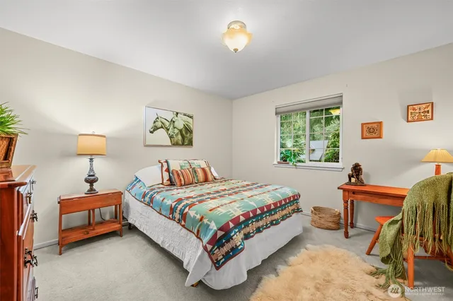 a bedroom with a bed and a table in it