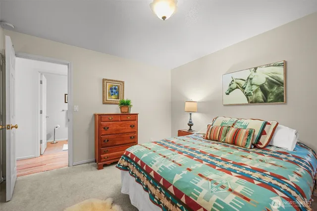 a bedroom with a bed and a dresser in it