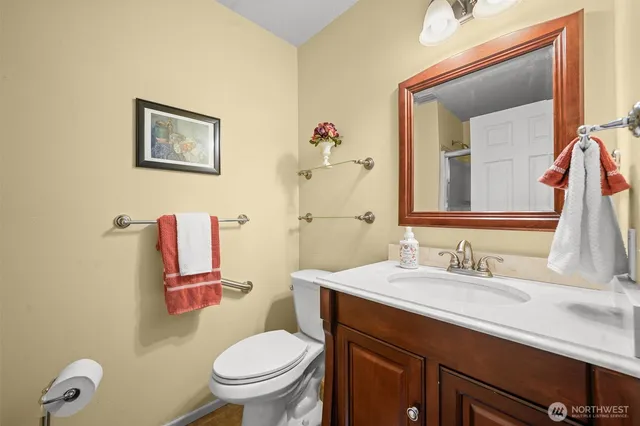 a bathroom with a toilet sink and mirror