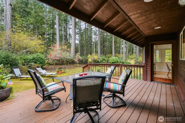 a view of a chairs and table in patio with wooden floor