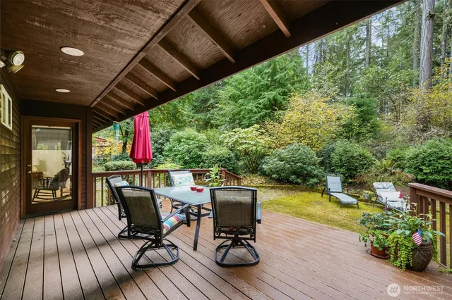 a view of a swimming pool with a patio and garden