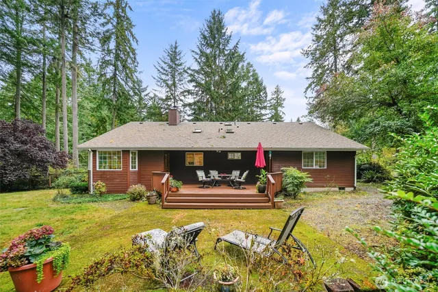 a view of a house with swimming pool and chairs