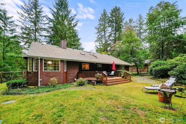 a view of a patio with table and chairs under an umbrella