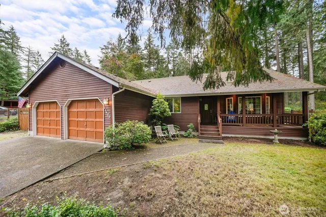 a view of a house with a yard and sitting area