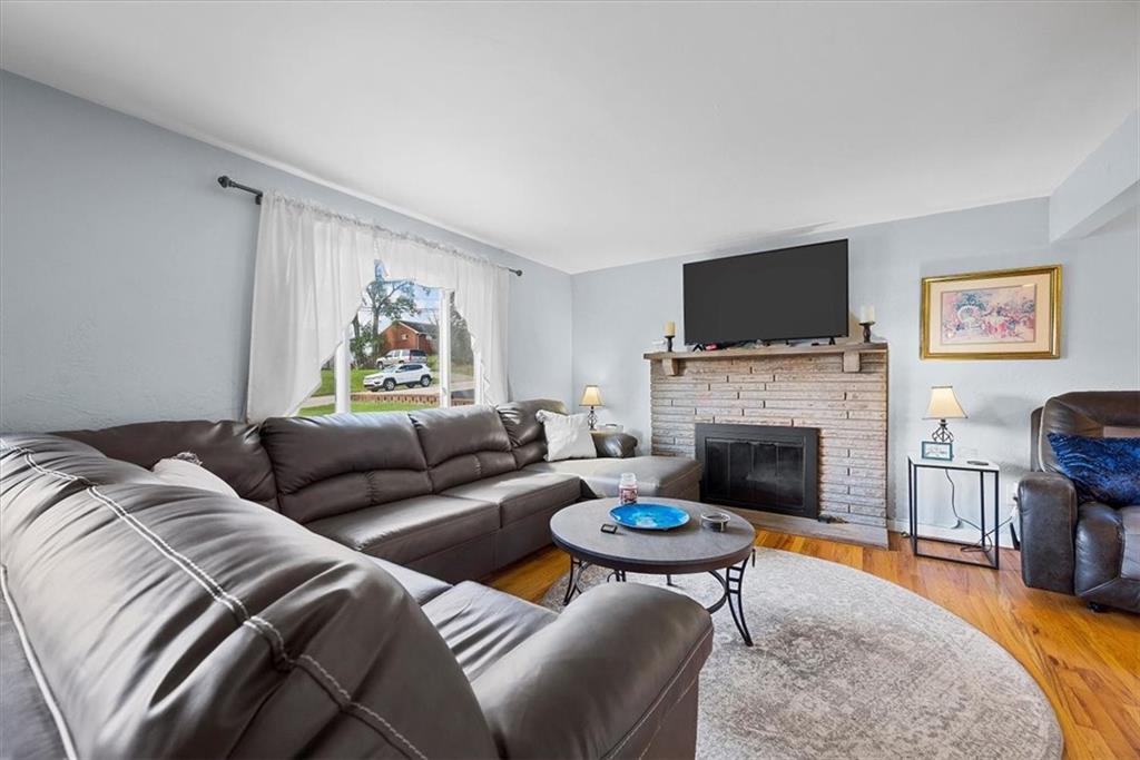951 Highview Road Pittsburgh, PA 15234 - Photo 5 of 25 a living room with furniture a fireplace and a flat screen tv