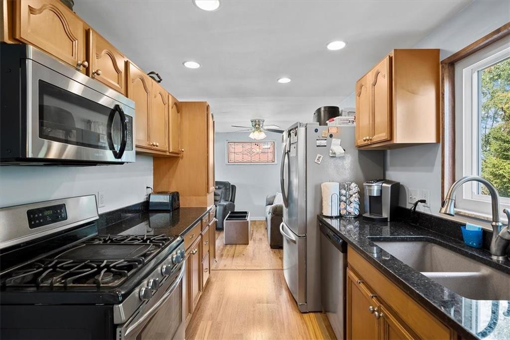 951 Highview Road Pittsburgh, PA 15234 - Photo 8 of 25 a kitchen with stainless steel appliances granite countertop a stove a sink dishwasher a refrigerator and a microwave