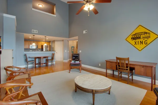 a living room with furniture and a chandelier