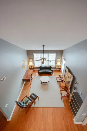a living room with furniture and a wooden floor