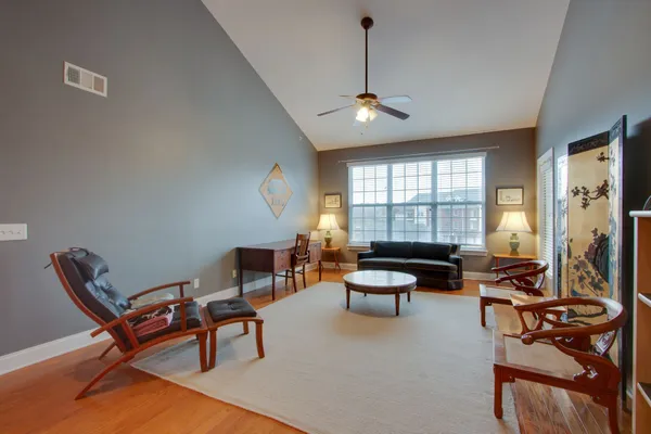 a living room with furniture a fireplace and a window