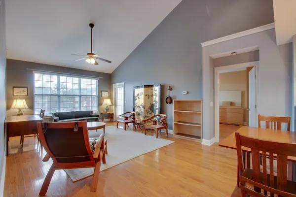 a living room with furniture a window and a flat screen tv
